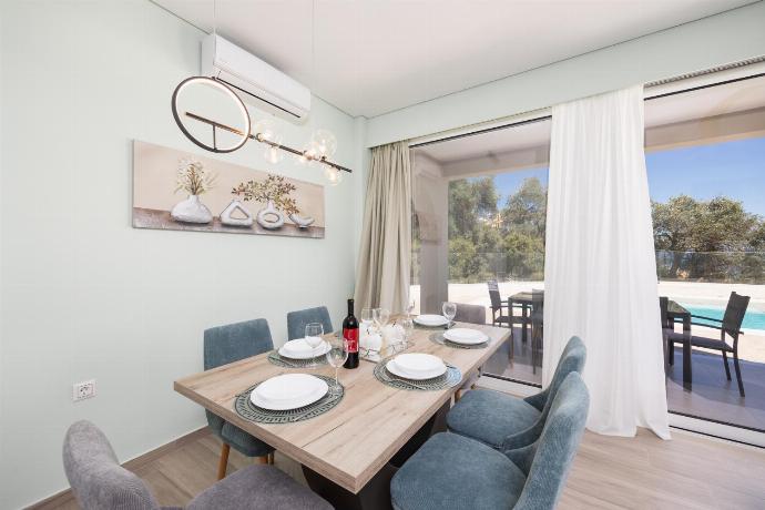 Open-plan living room with sofa, dining area, kitchen, A/C, WiFi internet, and satellite TV . - Villa Daisy . (Photo Gallery) }}