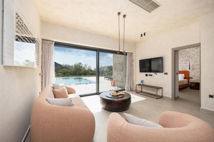 Open-plan living room with sofa, dining area, kitchen, A/C, WiFi internet, and satellite TV . - Villa Lilia . (Photo Gallery) }}
