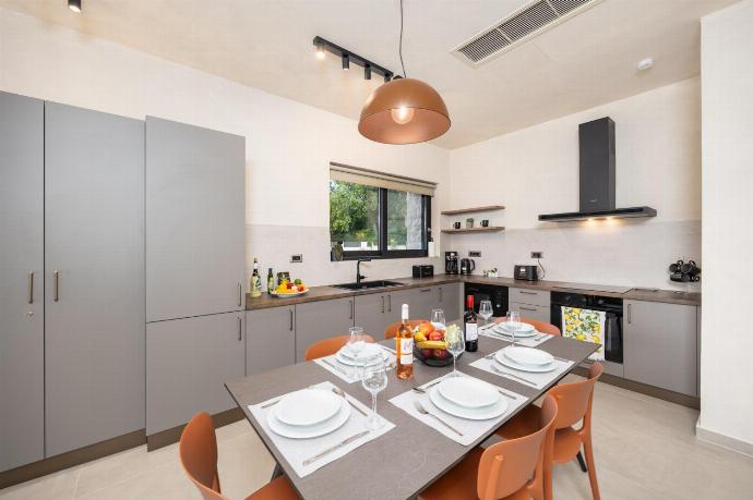Open-plan living room with sofa, dining area, kitchen, A/C, WiFi internet, and satellite TV . - Villa Lilia . (Photo Gallery) }}