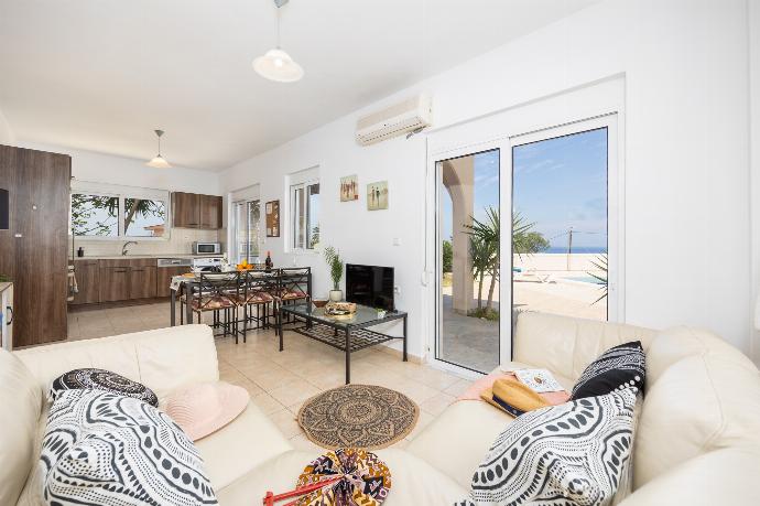 Open-plan living room with sofa, dining area, kitchen, A/C, WiFi internet, and satellite TV . - Villa Maia . (Photo Gallery) }}