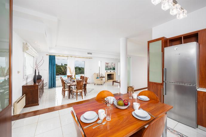 Open-plan living room on first floor with sofas, dining area, kitchen, ornamental fireplace, A/C, and WiFi internet . - Villa Noulia . (Photo Gallery) }}