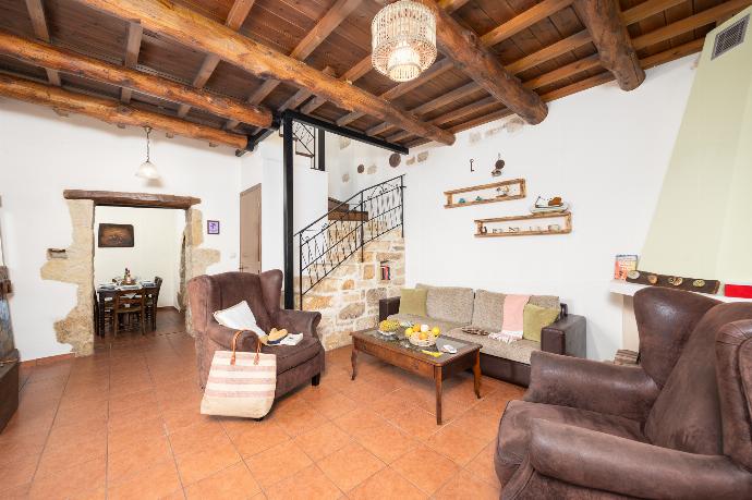 Living room with sofa, ornamental fireplace, A/C, WiFi internet, and satellite TV . - Villa Kourkoulios . (Photo Gallery) }}