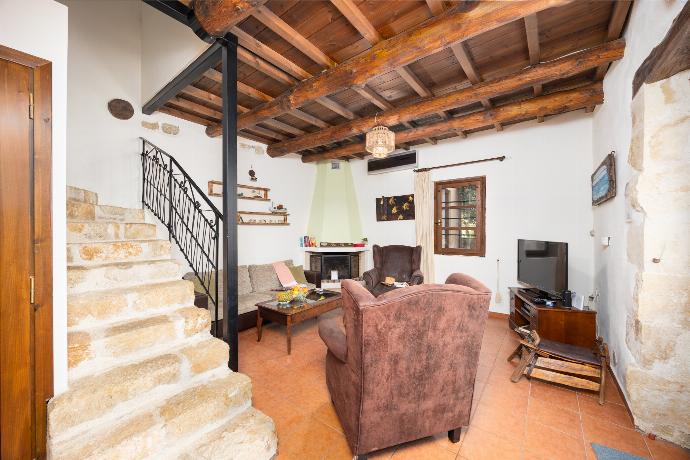 Living room with sofa, ornamental fireplace, A/C, WiFi internet, and satellite TV . - Villa Kourkoulios . (Photo Gallery) }}