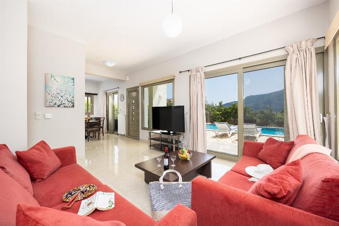 Open-plan living room with sofas, dining area, kitchen, WiFi internet, and satellite TV . - Villa Irineos . (Photo Gallery) }}