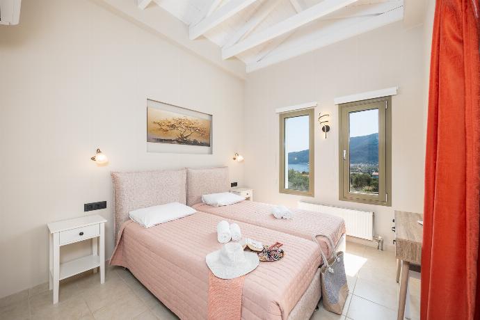 Twin bedroom with en suite bathroom and A/C . - Villa Irineos . (Photo Gallery) }}