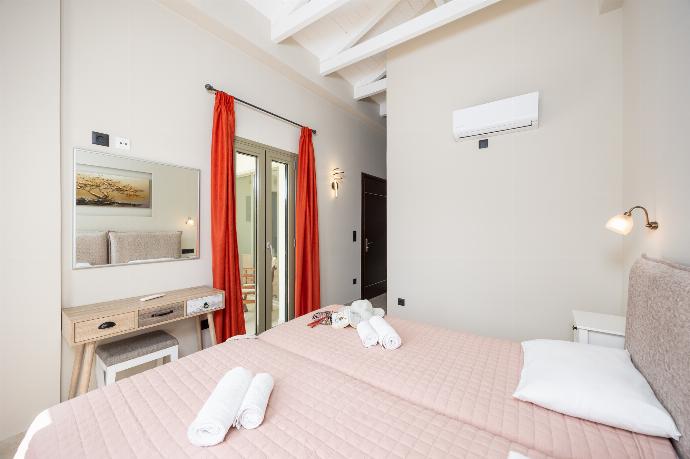 Twin bedroom with en suite bathroom and A/C . - Villa Irineos . (Photo Gallery) }}
