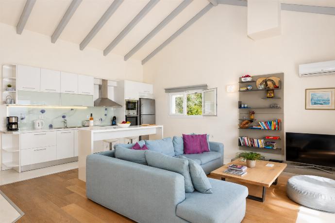 Open-plan living room with sofa, dining area, kitchen, A/C, WiFi internet, and satellite TV . - Villa Penelope . (Photo Gallery) }}