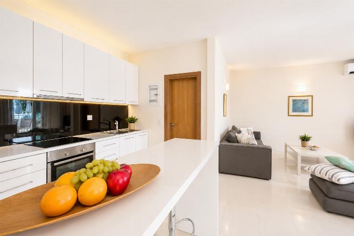 Open-plan living room with sofa, dining area, kitchen, A/C, WiFi internet, and satellite TV . - Villa Penelope . (Photo Gallery) }}