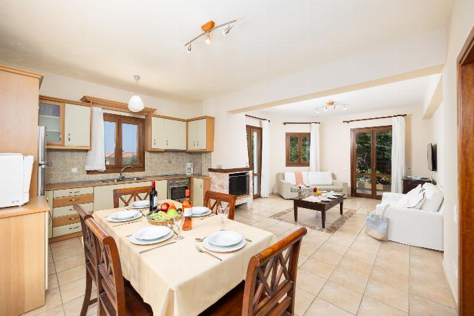 Open-plan living room with sofas, dining area, kitchen, ornamental fireplace, A/C, WiFi internet, and satellite TV . - Ionian Blue . (Photo Gallery) }}