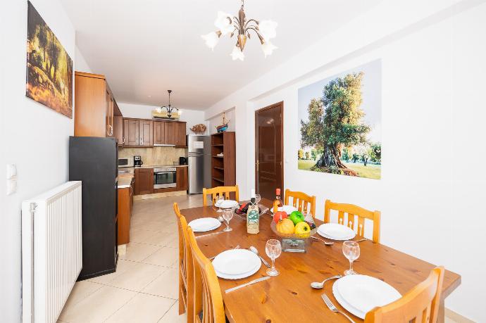 Equipped kitchen with A/C and dining area . - Villa Atlantis . (Photo Gallery) }}
