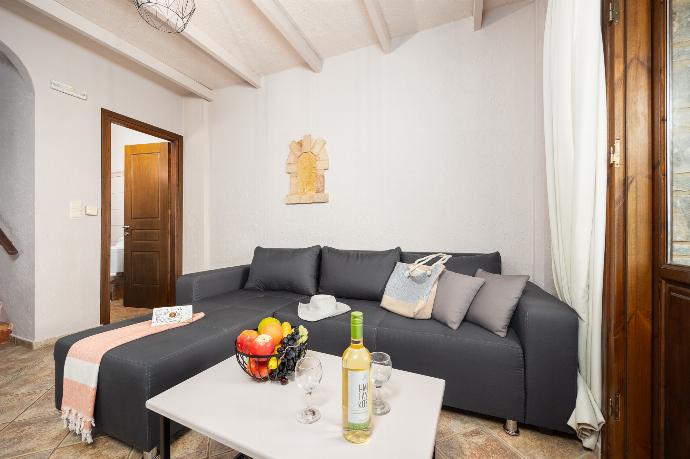 Unit 1: open-plan living room with sofa, dining area, kitchen, A/C, WiFi internet, and satellite TV . - Panorama II Villas . (Photo Gallery) }}