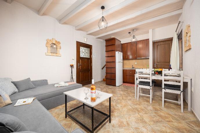 Unit 2: open-plan living room with sofa, dining area, kitchen, A/C, WiFi internet, and satellite TV . - Panorama II Villas . (Photo Gallery) }}