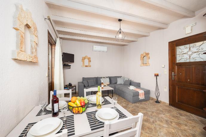 Unit 2: open-plan living room with sofa, dining area, kitchen, A/C, WiFi internet, and satellite TV . - Panorama II Villas . (Photo Gallery) }}