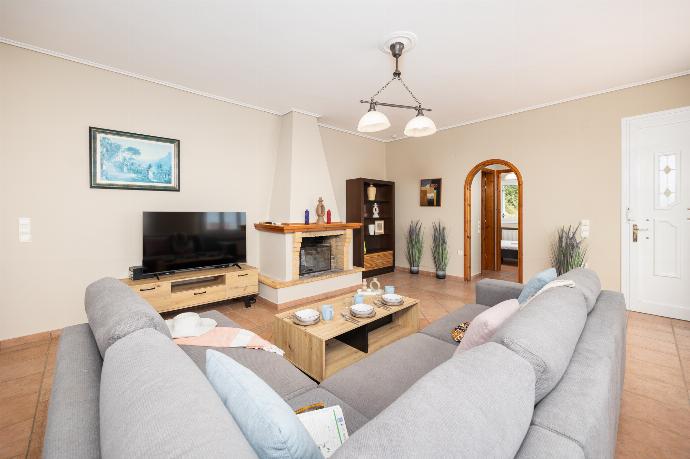 Living room with sofa, ornamental fireplace, A/C, WiFi internet, satellite TV, and sea views . - Villa Doreta . (Photo Gallery) }}