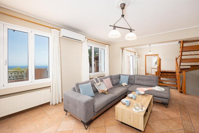 Living room with sofa, ornamental fireplace, A/C, WiFi internet, satellite TV, and sea views . - Villa Doreta . (Photo Gallery) }}