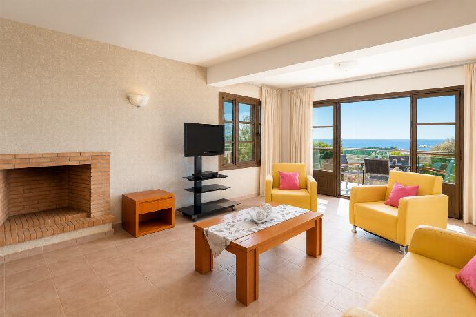 Open-plan living room with sofa, dining area, kitchen, A/C, WiFi internet, and satellite TV . - Villa Athina . (Photo Gallery) }}