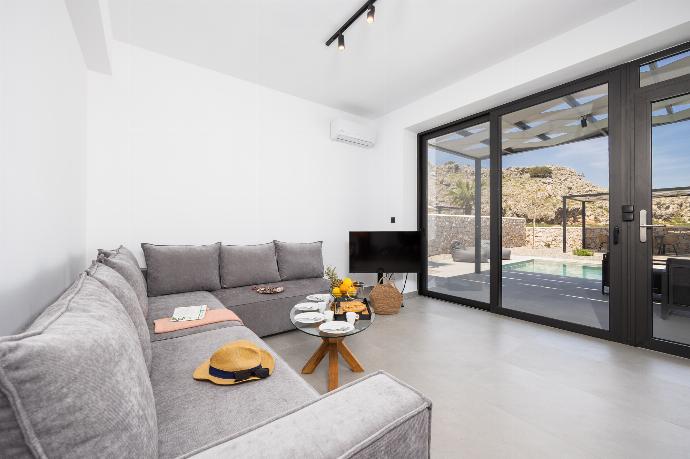 Open-plan living room with sofa, dining area, kitchen, A/C, WiFi internet, and satellite TV . - Villa 12 Chado . (Photo Gallery) }}