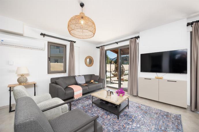 Open-plan living room with sofa, dining area, kitchen, A/C, WiFi internet, and satellite TV . - Villa Lidya . (Photo Gallery) }}