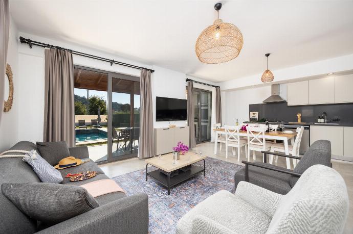 Open-plan living room with sofa, dining area, kitchen, A/C, WiFi internet, and satellite TV . - Villa Lidya . (Photo Gallery) }}