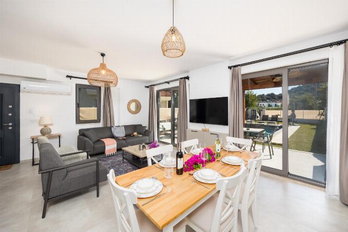 Open-plan living room with sofa, dining area, kitchen, A/C, WiFi internet, and satellite TV . - Villa Lidya . (Photo Gallery) }}
