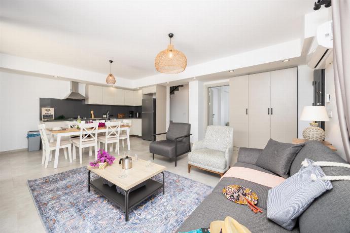 Open-plan living room with sofa, dining area, kitchen, A/C, WiFi internet, and satellite TV . - Villa Lidya . (Photo Gallery) }}