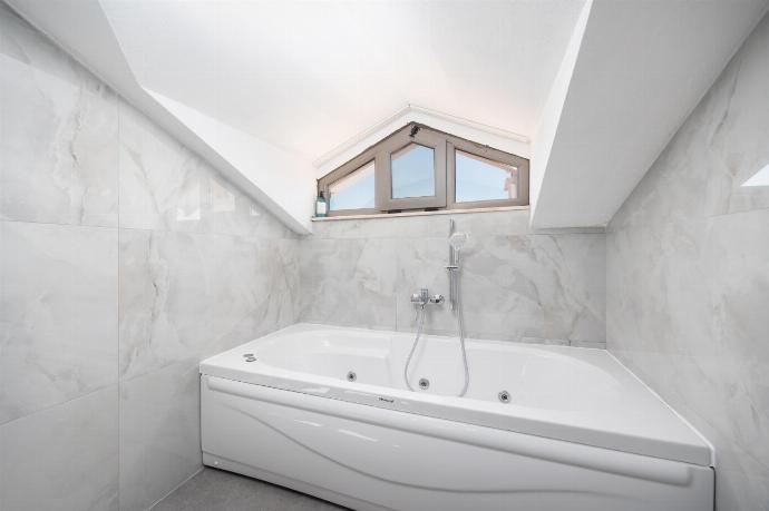 En suite bathroom with bath and shower . - Villa Lidya . (Photo Gallery) }}