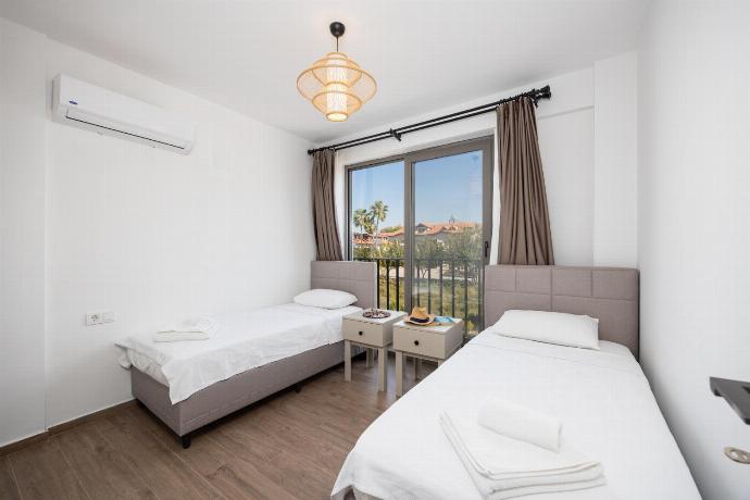 Twin bedroom with en suite bathroom and A/C . - Villa Lidya . (Photo Gallery) }}