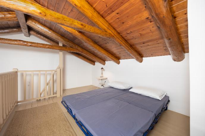 Main building: Bedroom with mezzanine, double bed, folding bed, en suite bathroom, and A/C . - Villa Nafsika . (Photo Gallery) }}