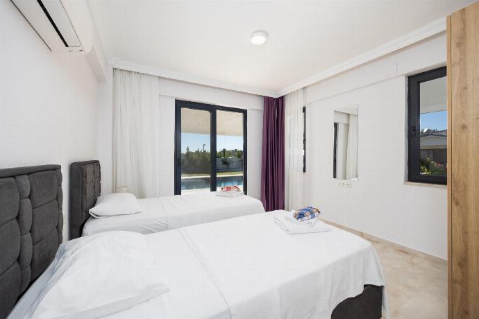 Main building: twin bedroom with en suite bathroom and A/C . - Villa Tolga . (Photo Gallery) }}