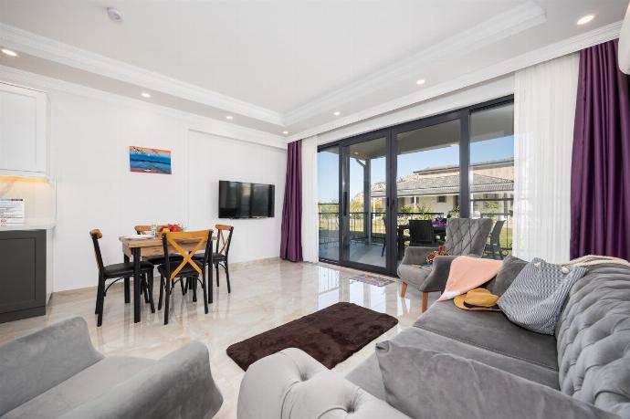 Annex: open-plan living room with sofa, dining area, kitchen, A/C, WiFi internet, and satellite TV . - Villa Tolga . (Photo Gallery) }}