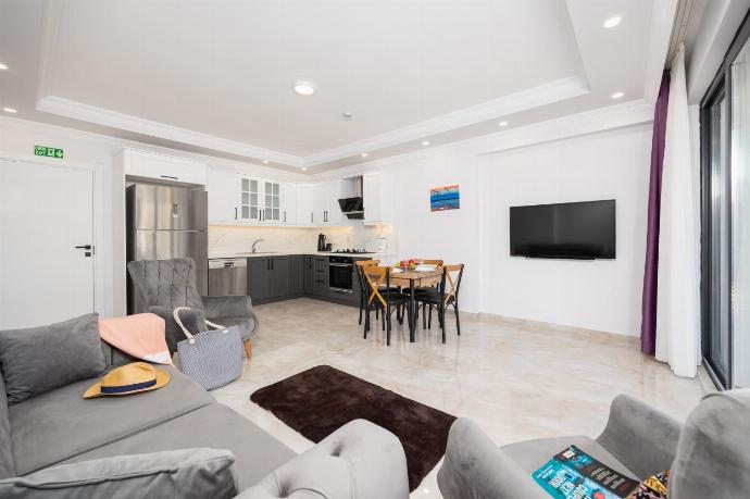 Annex: open-plan living room with sofa, dining area, kitchen, A/C, WiFi internet, and satellite TV . - Villa Tolga . (Photo Gallery) }}