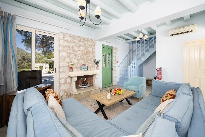 Open-plan living room with sofa, dining area, kitchen, ornamental fireplace, A/C, WiFi internet, and satellite TV . - Villa Anemus . (Photo Gallery) }}