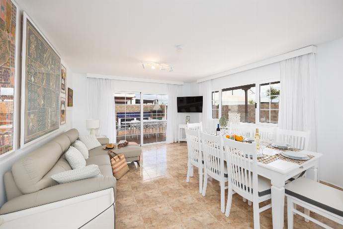 Living room with sofa, dining area, A/C, WiFi internet, and satellite TV . - Villa Eugina . (Photo Gallery) }}