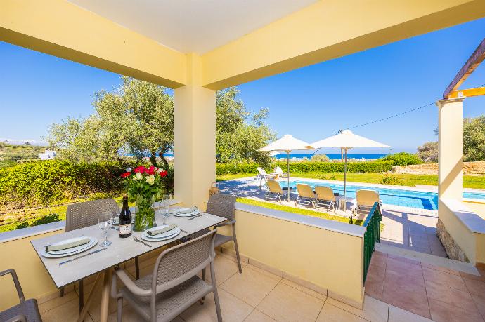 Sheltered terrace area with sea views . - Villa Eleni . (Photo Gallery) }}
