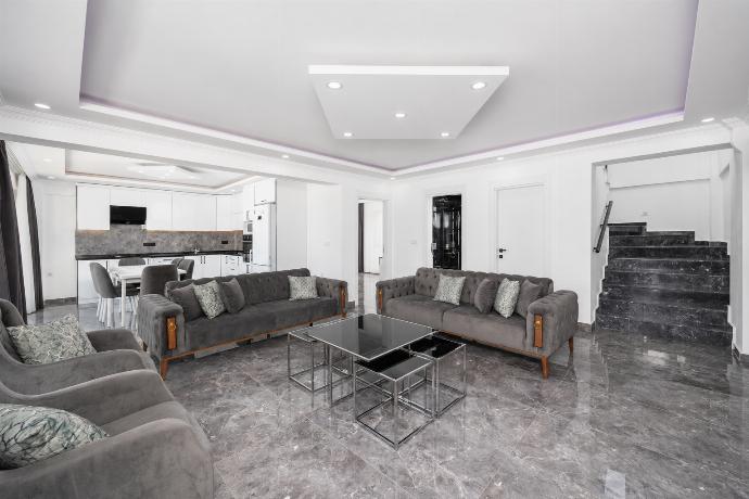 Open-plan living room with sofas, dining area, kitchen, A/C, WiFi internet, and satellite TV . - Villa Grand Yasar 4 . (Galleria fotografica) }}