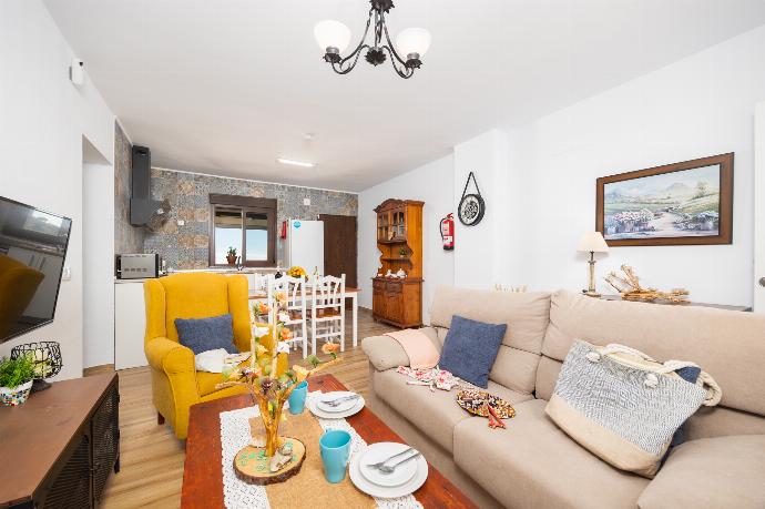 Open-plan living room with sofa, dining area, kitchen, ornamental fireplace, WiFi internet, and satellite TV . - Villa El Cortijo . (Photo Gallery) }}