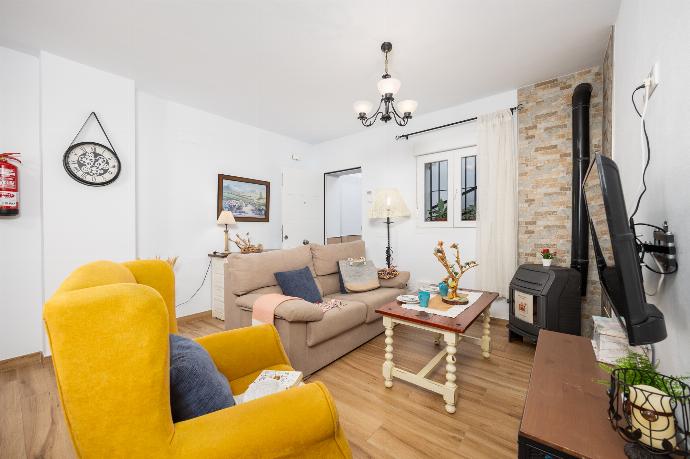 Open-plan living room with sofa, dining area, kitchen, ornamental fireplace, WiFi internet, and satellite TV . - Villa El Cortijo . (Photo Gallery) }}