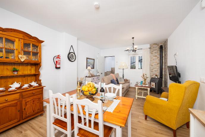 Open-plan living room with sofa, dining area, kitchen, ornamental fireplace, WiFi internet, and satellite TV . - Villa El Cortijo . (Photo Gallery) }}