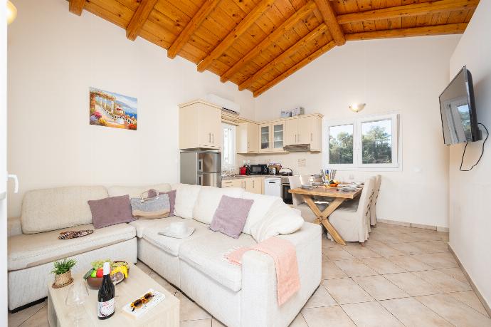 Open-plan living room with sofa, dining area, kitchen, A/C, WiFi internet, and satellite TV . - Villa Iremia . (Photo Gallery) }}