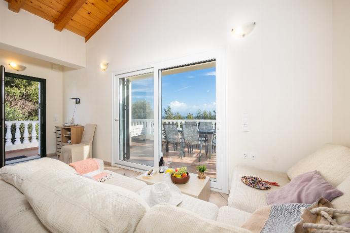 Open-plan living room with sofa, dining area, kitchen, A/C, WiFi internet, and satellite TV . - Villa Iremia . (Photo Gallery) }}