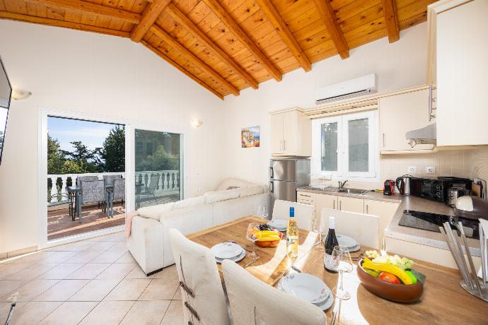 Open-plan living room with sofa, dining area, kitchen, A/C, WiFi internet, and satellite TV . - Villa Iremia . (Photo Gallery) }}