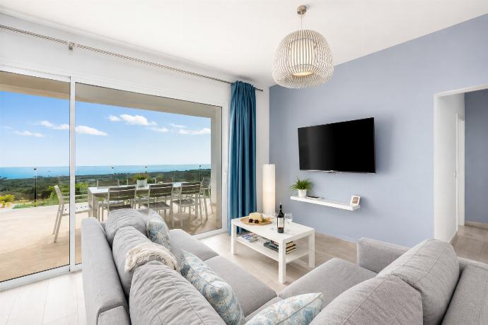 Open-plan living room with sofa, dining area, kitchen, A/C, WiFi internet, satellite TV, and sea views . - The View . (Photo Gallery) }}