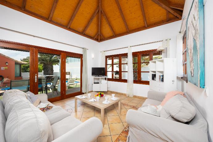 Open-plan living room with sofas, dining area, kitchen, WiFi internet, and satellite TV . - Villa Brisa del Mar 12 . (Photo Gallery) }}
