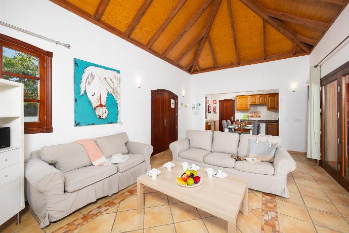 Open-plan living room with sofas, dining area, kitchen, WiFi internet, and satellite TV . - Villa Brisa del Mar 12 . (Photo Gallery) }}