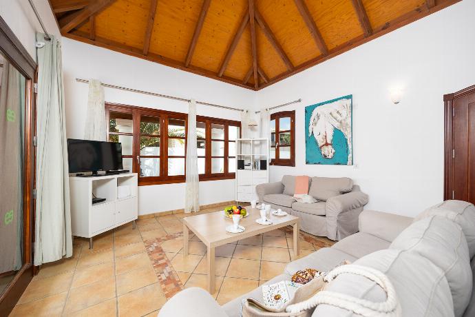Open-plan living room with sofas, dining area, kitchen, WiFi internet, and satellite TV . - Villa Brisa del Mar 12 . (Photo Gallery) }}