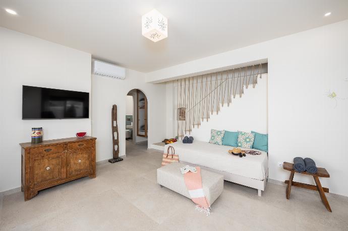 Open-plan living room with sofa, dining are, kitchen, A/C, WiFi internet, and satellite TV . - Villa Erofili . (Photo Gallery) }}
