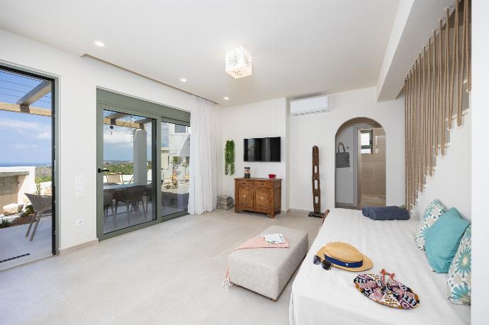 Open-plan living room with sofa, dining are, kitchen, A/C, WiFi internet, and satellite TV . - Villa Erofili . (Photo Gallery) }}