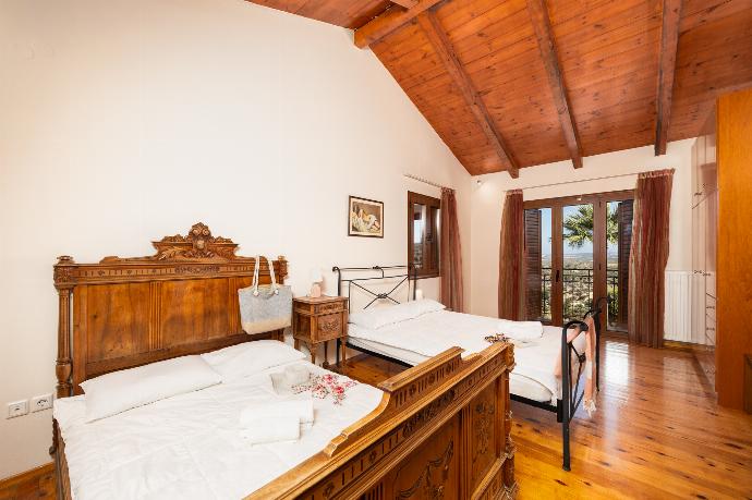 Bedroom with two double beds, en suite bathroom, and A/C . - Teacher Cottage . (Photo Gallery) }}