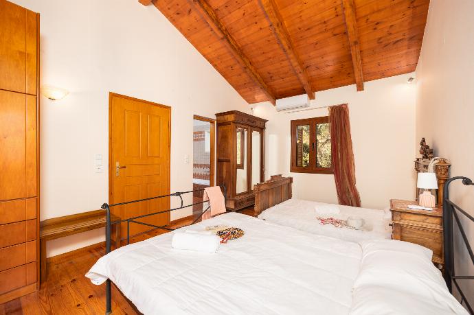 Bedroom with two double beds, en suite bathroom, and A/C . - Teacher Cottage . (Photo Gallery) }}