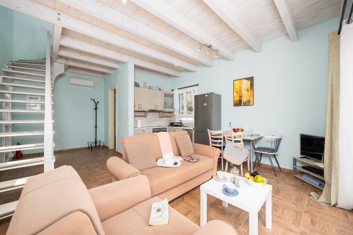Open-plan living room with sofas, dining area, kitchen, A/C, WiFi internet, satellite TV, and sea views . - Villa Magda Dione . (Photo Gallery) }}
